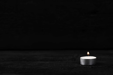 candle with burning fire on black