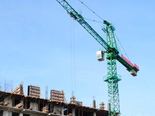 Crane. Crane near building. Construction site.