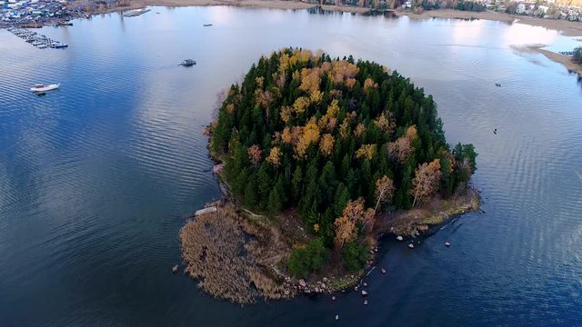 Espoo Finland 10.21.2017 Circling around a small island with trees in autumn colour