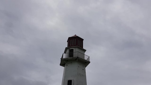 Time lapse of a lighthouse with gray clouds moving in the background. Shot in Batanes, Philippines.