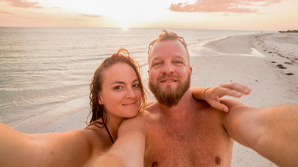 LOVERS KEY, FORT MYERS BEACH, FLOIRDA/USA 11/4/15: Young couple enjoying the sunset on the beach.