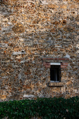 Traditional Paris region old stone wall, typical "meulière" style, closeup with a window, Chatillon, France