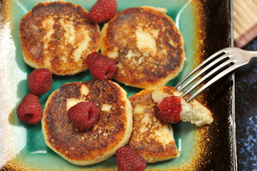 cheesecakes or cheese pancake with fresh raspberries