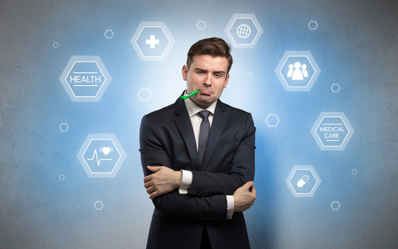 Young businessman with medical care, pills concept
