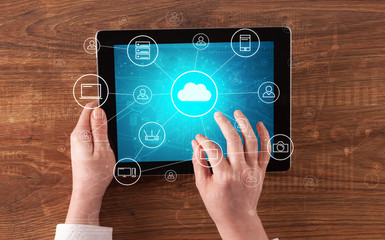 Hand touching tablet with cloud computing and online storage concept
