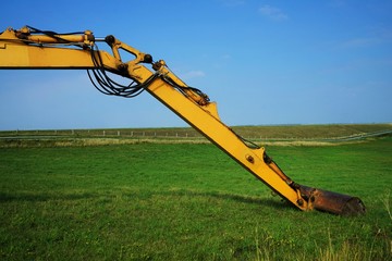 Large excavator on the dike in Schleswig Holstein