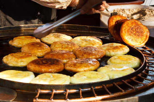 Korean hotteok being cooked by a street vendor in Seoul, South Korea.