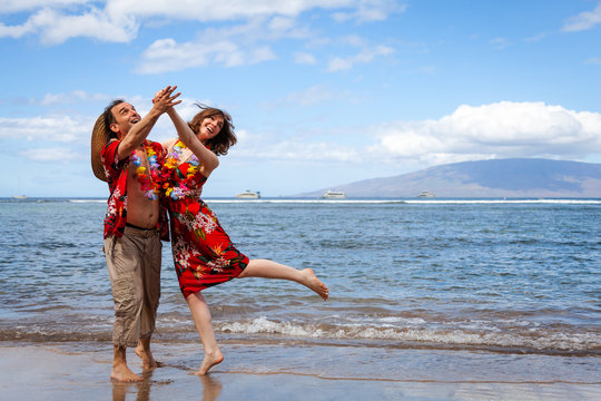 Happy Couple on Vacation in Hawaii Dancing on the Beach