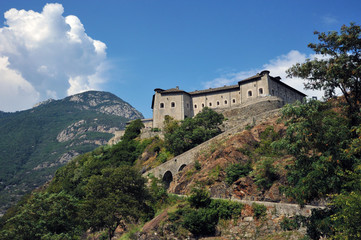 Fototapeta na wymiar Fort Bard, Valle d'Aosta, Italy - August 21, 2018: Historic military construction defense Fort Bard. Medieval fortress in Italian Alps.
