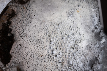 An egg frying in butter and oil in a carbon steel skillet