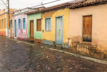 Fototapeta na wymiar Colorful houses on cobblestone street, rain day, Andaraí, Chapada Diamantina, Bahia, Brazil