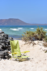Green chair in Corralejo Beach, Fuerteventura Island, Canary Islands, Spain