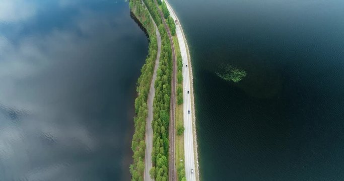 Punkaharju Finland, road and rail track between two lakes on a summer day seen from the air with drone