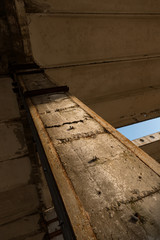 A deserted industrial plant site with old deserted structure on a beautiful sunset.