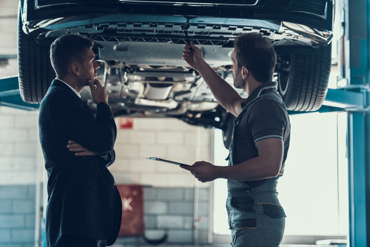 Auto Mechanic Showing Client Car Problem