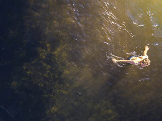 top view of young man walk in the sea water on the beachon summer resort