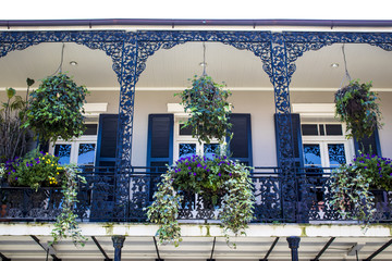 Black and White Balcony with Spring Flower Baskets Overlooking the French Quarter in New Orleans, Louisiana, USA