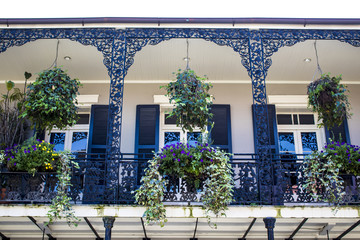 Black and White Balcony with Spring Flower Baskets Overlooking the French Quarter in New Orleans,...