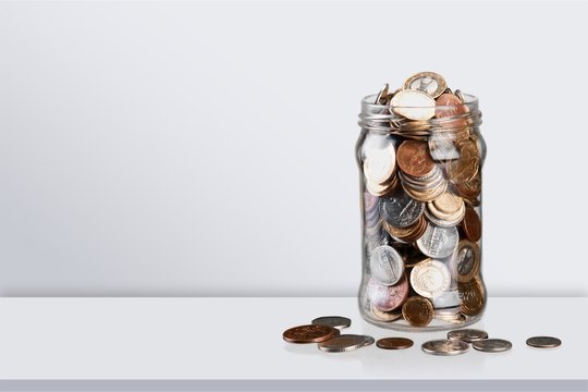 Money Jar with  coins on background