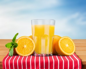 Orange juice and slices of orange on background