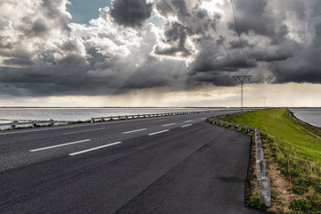 Curved causeway with powerline in denmark