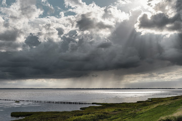 Dramatic sky over mud flat in Denmark