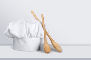 White chef hat and wooden spoons