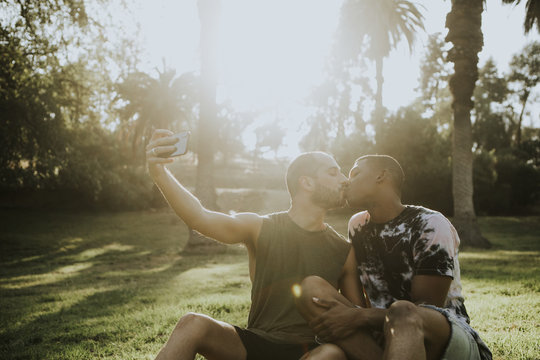 Gay couple taking a selfie in the summer