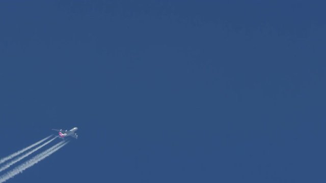 airplane and inversion trails against the blue sky