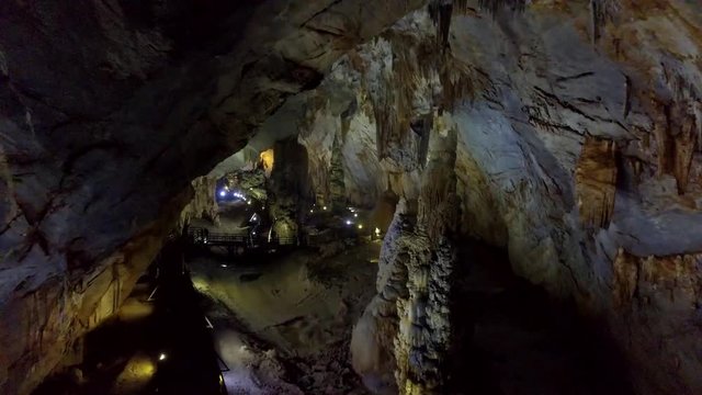 flashlight beam runs along mystical huge cave bottom
