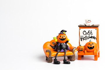 Wizard pumpkin halloween sitting on a orange sofa and label with a cafe halloween text and copy space.