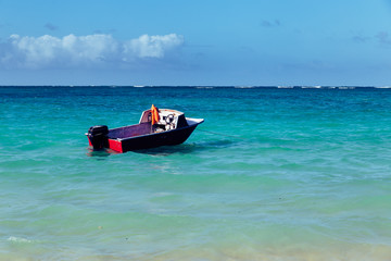 Beautiful Lanikai beach  with turquoise water and a motor boat, Hawaii