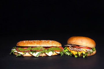 Panini, burger with sesame bun on a dark background