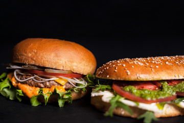 Panini, burger with sesame bun on a dark background