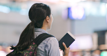 Woman checking the flight number in the airport