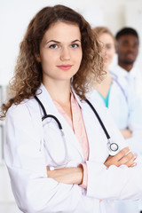 Fototapeta premium Happy doctor woman with medical staff at the hospital