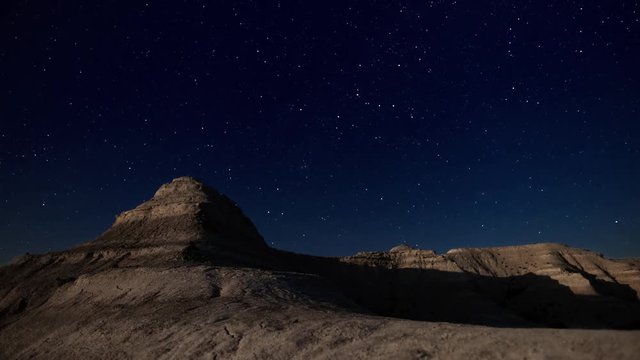Moon looking stone canyon on the night starry sky background in Kasakhstan. Time lapse 4K shot.