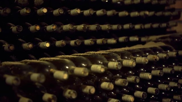 Italy wine bottles without label on the shelf inside a cellar.