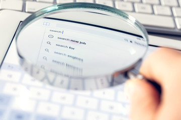 Searching online using a magnifying glass.