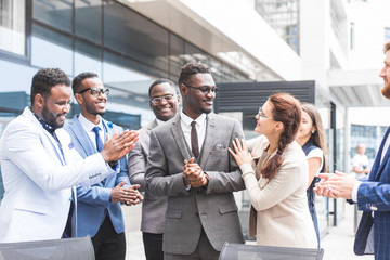 Portrait of an handsome businessman in front of his team. recognition, movement on the career ladder, success in business