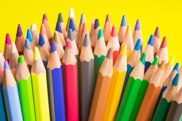 Back to school set multicolored pencils colorful making forms side view on a yellow backround.