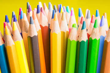 Back to school set multicolored pencils colorful making forms side view on a yellow backround.