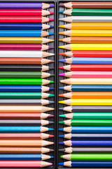 Color Pencils with plastic case isolated on Black Background close up. Colored style view top flat lay with free copy space for design or text. Back to school theme.