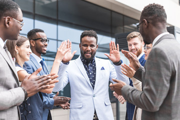 Obraz premium Portrait of an handsome businessman in front of his team. recognition, movement on the career ladder, success in business