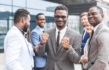 Portrait of an handsome businessman in front of his team. recognition, movement on the career ladder, success in business