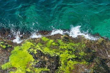 rock in the sea, blue waves, rocks, foam, raging sea, spray, top view down