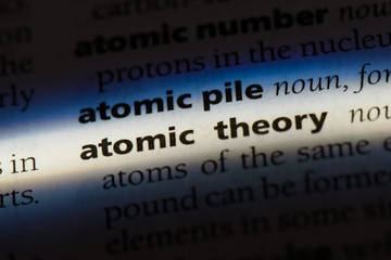 atomic theory word in a dictionary. atomic theory concept.