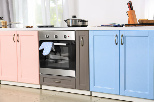Bright modern furniture with stove in kitchen
