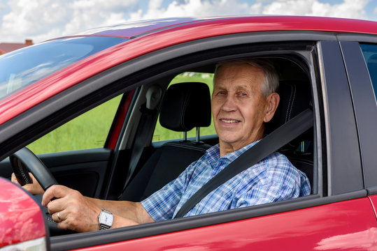 Cheerful old man car driver