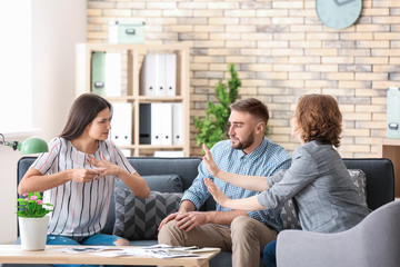Psychologist working with married couple in office
